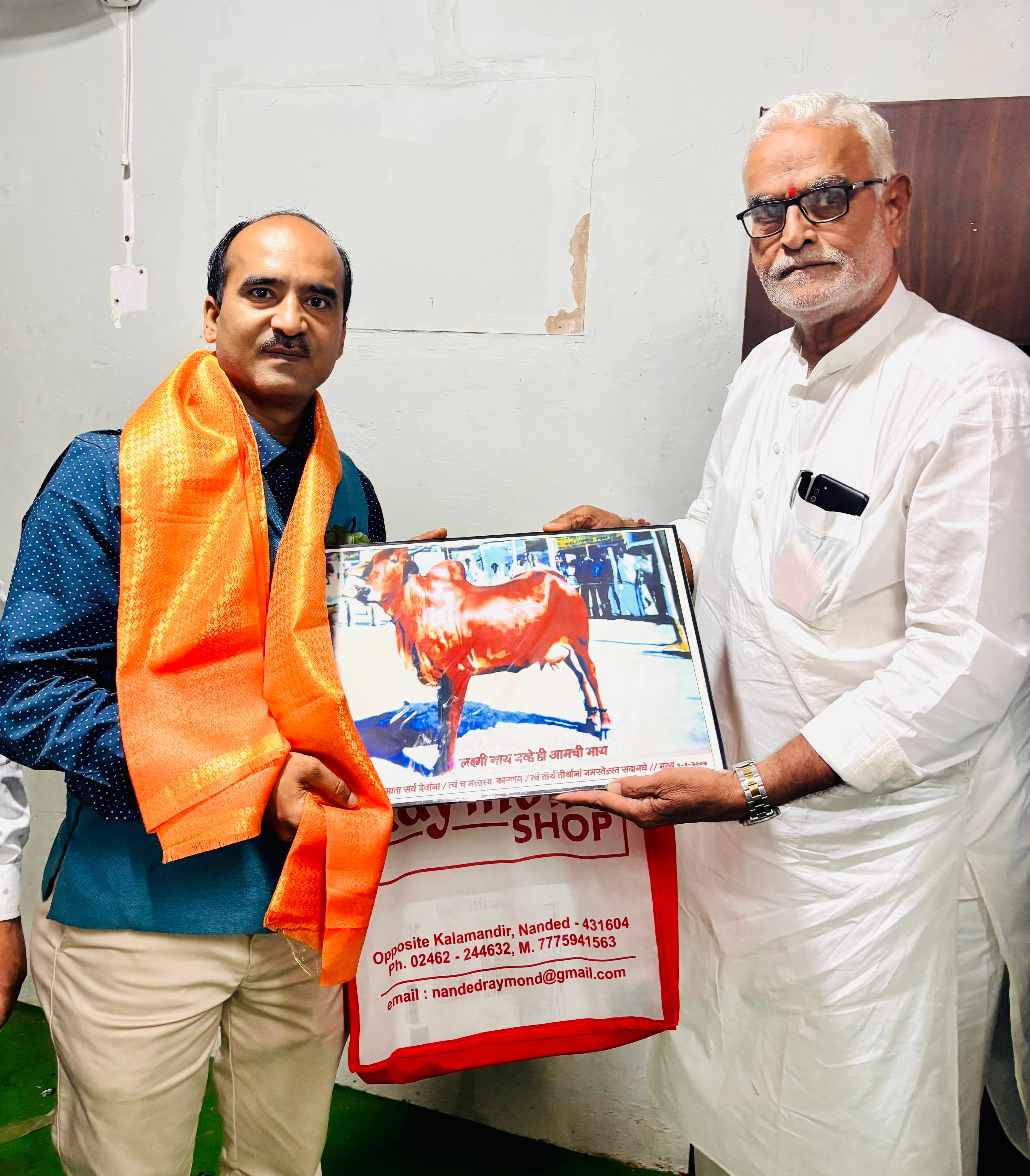 Felicitation exchange between two agricultural representatives